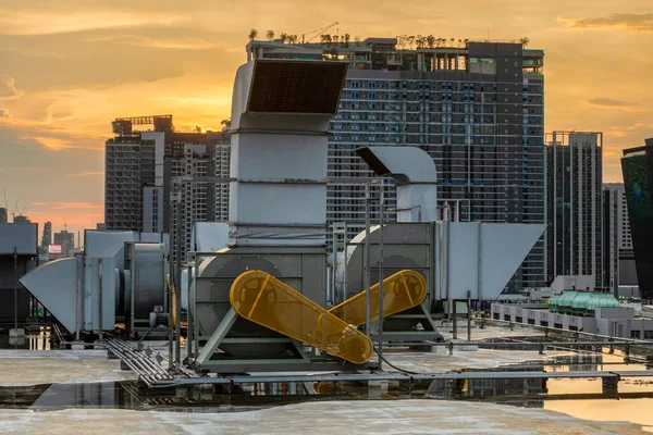 Industrial centrifugal fan and Exhaust vents of industrial air conditioning in ventilation systems. Skyscraper roof top from high building.