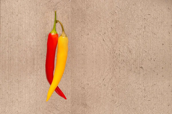 Two Hot Peppers Red Yellow Beige Background — 스톡 사진