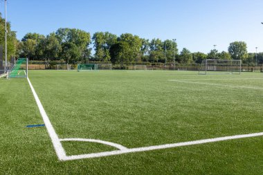 Shot of football field with artificial turf and white markings for practices