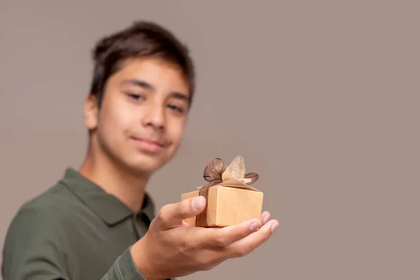 Shot Young Boy Giving Gift Holding Out Beige Gift Box — 图库照片