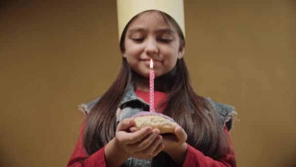 Portrait of little girl blows out a festive candle on a birthday, happy emotions — Stock Video