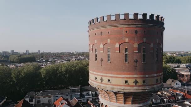 Drone view of old tower in small old European city in summer. Aerial Cityscape in Netherlands. Head of old tower in the center of small European city shot from air. High quality 4k footage