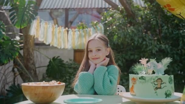 Birthday Girl Looks Camera Sitting Backyard Party Sunny Day Green — Stock Video