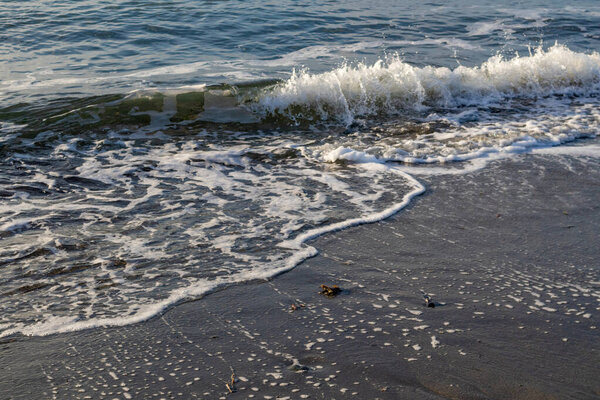 moody shallow winter surf in pacific ocean