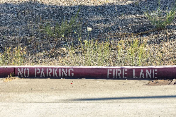 Fire lane with dirt gravel area behind it — Stock Photo, Image