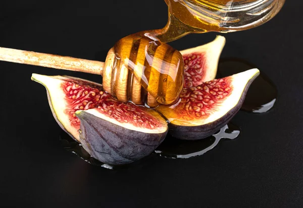Cut Figs Honey Isolated Black Background — стоковое фото