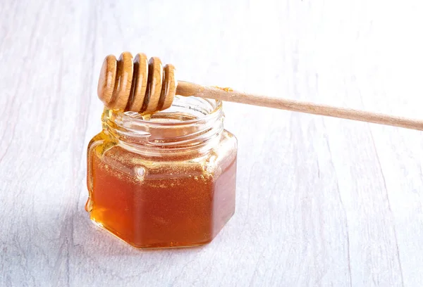 Honey Glass Jar Honey Spoon Light Wooden Background — стоковое фото