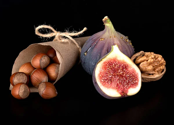 Whole Chopped Figs Walnuts Hazelnuts Isolated Black Background — стоковое фото