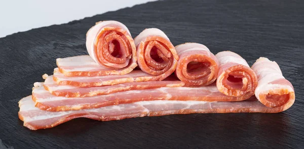 Rolls Fresh Bacon Black Cutting Board — Stock Fotó