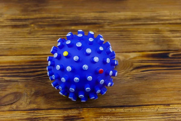 Blue dog toy ball on wooden background. Top view