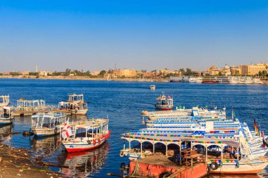 Luxor, Egypt - December 11, 2018: Tourist boats moored near the shore of Nile river in Luxor, Egypt