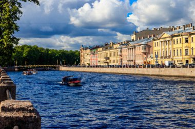St. Petersburg, Russia - June 26, 2019: Tourist boats sailing on the Fontanka river near Panteleymonovsky Bridge in Saint Petersburg, Russia
