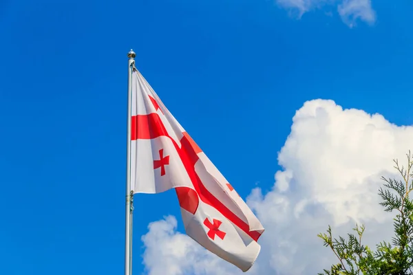 Georgian flag against blue sky