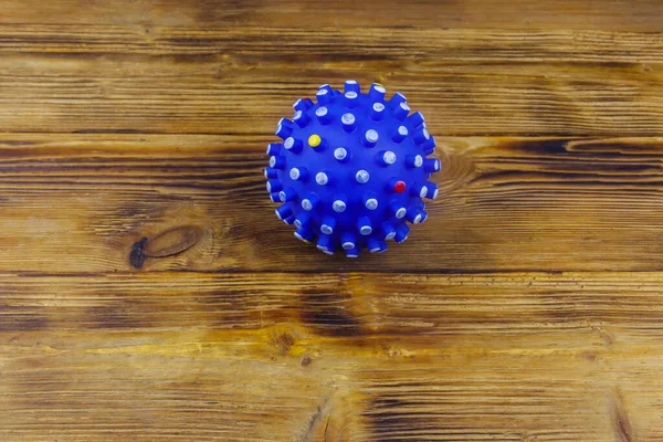 Blue dog toy ball on wooden background. Top view