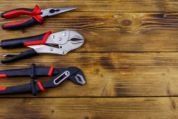 Set Different Pliers Wooden Background Top View Copy Space — Stock Photo, Image