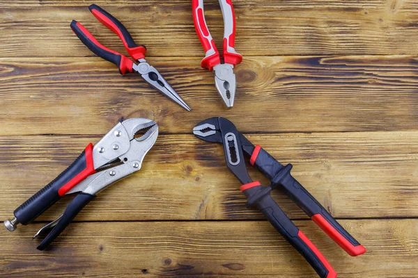 Set Different Pliers Wooden Background Top View — Stock Photo, Image