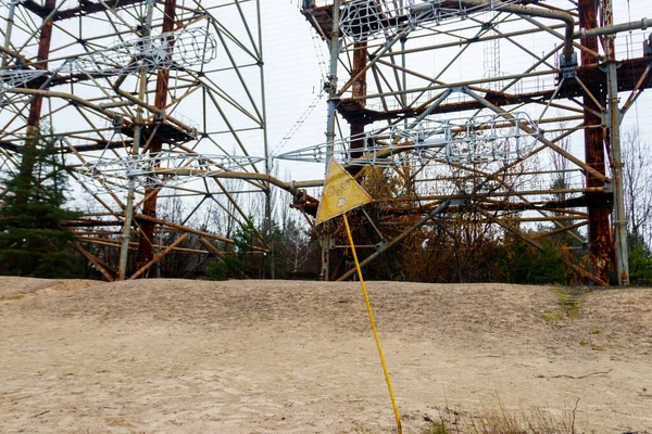 Radiation warning sign in front of Duga, a Soviet over-the-horizon (OTH) radar system as part of the Soviet anti-ballistic missile early-warning network, inside the Chernobyl Exclusion Zone in Ukraine