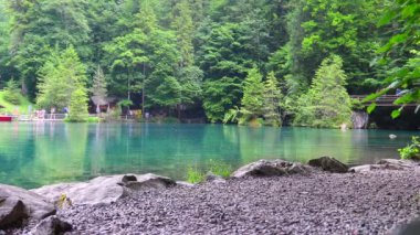 Blausee lake or Blue Lake during rain in Bernese Oberland, Kandergrund, Switzerland