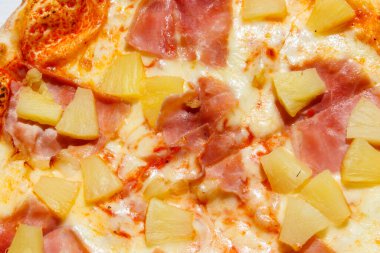 Texture of a delicious fresh hawaiian pizza with sausage, pineapple and cheese