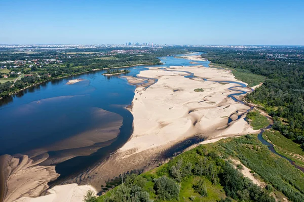 Low water level in Vistula river, effect of drought seen from the bird\'s eye perspective. City Warsaw in a distance.