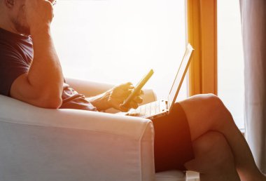 Working from home on the laptop. Wearing casual comfort outfit in home office.