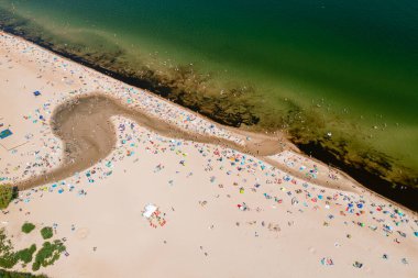 Baltic coast, people having bath in the sea and in the Oliwski stream mouth to the sea during hot summertime weekend
