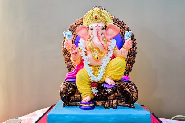 Hindu God Ganesha Lovely Statue. Colorful Lord Ganesha. Brown Background. Main Hindu God. Hinduism Religion and Culture.