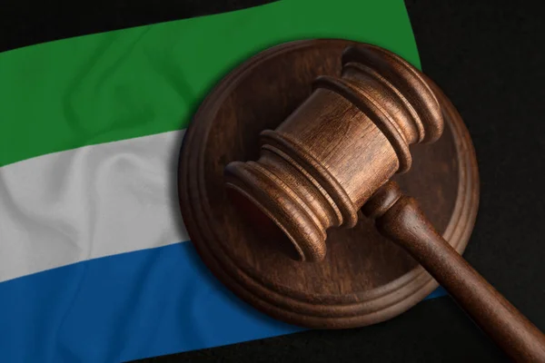 Judge Gavel and flag of Sierra Leone. Law and justice in Sierra Leone. Violation of rights and freedoms.