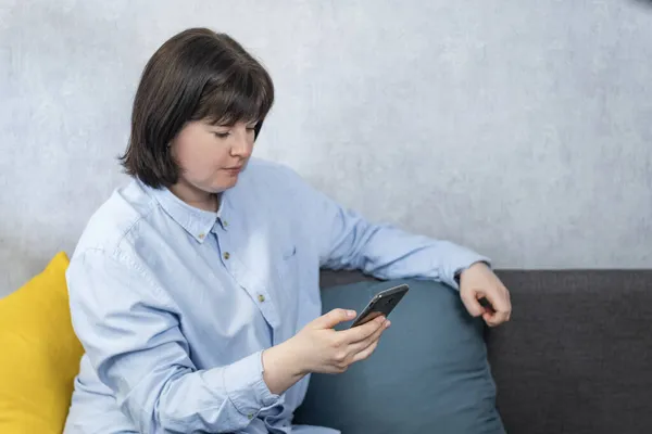 Plump Young Woman Strict Shirt Sits Couch Phone Hands — Stock Photo, Image