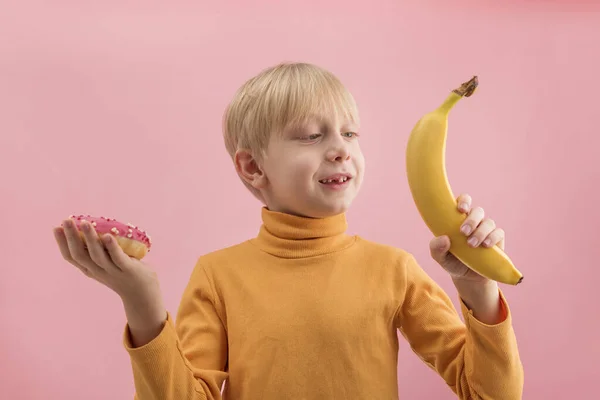 Young Blond Boy Choosing Fruits Sweets Child Holding Doughnut Banana — Foto Stock