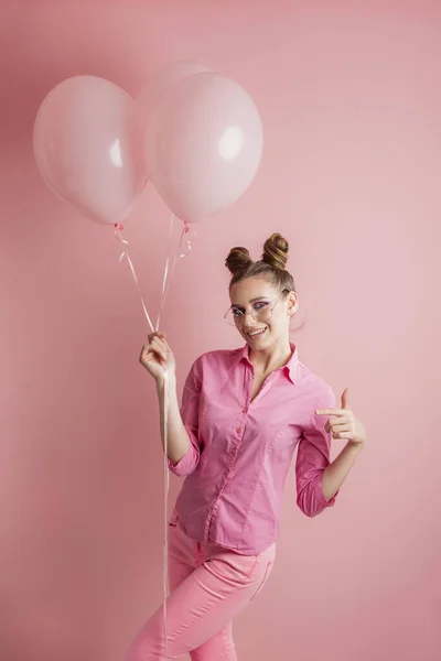 Teenagermädchen Pinkfarbener Kleidung Hält Luftballons Die Höhe Und Zeigt Etwas — Stockfoto