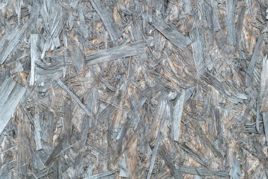 Sert bir yüzey. Parçacık tahtası ya da yonga tahtası. Mühendislik odunu. Soyut gri arkaplan