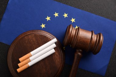 Flag of European Union, cigarettes and Judge gavel. Tobacco law. Smoking control in EU countries clipart