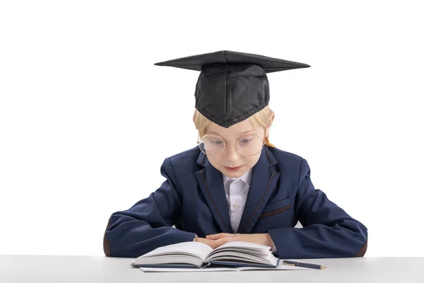 Boy Big Glasses Wears School Uniform Student Hat Sitting Table — Zdjęcie stockowe