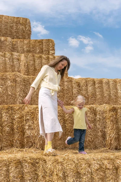 Beautiful Young Mother Walks Small Child Girl Hay Huge Haystacks — Photo