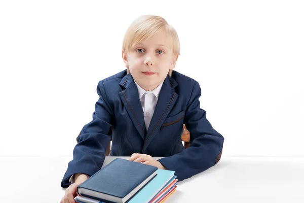 Blond Boy Years Old Jacket School Uniform Sits Table Stack —  Fotos de Stock