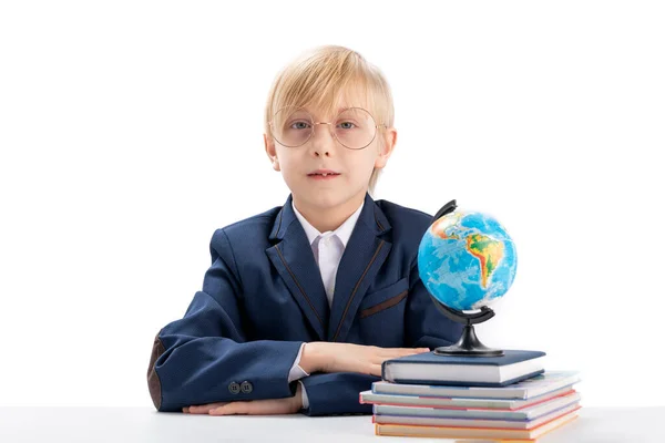 Excellent Boy Sits Table His Hands Folded Stares Seriously Camera — Zdjęcie stockowe