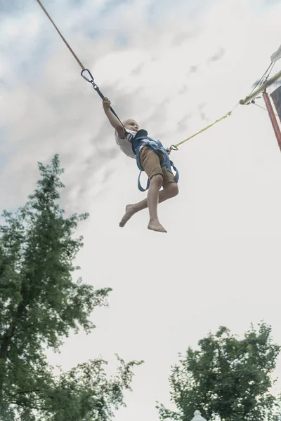 Little Boy Rides Trampoline Amusement Park Jumps High Sky Child — Stock Photo, Image