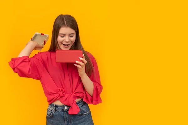 Surprised Young Woman Open Gift Box Looks Admiringly Yellow Background — Stock Photo, Image