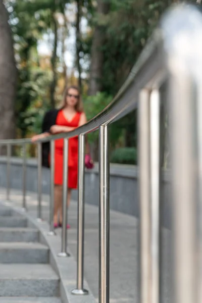 Young Woman Red Dress Stands Handrail Focus Railing Steel Railing — Stock Photo, Image