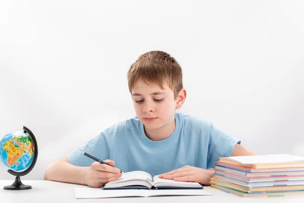 Boy Years Old Does Homework Schoolboy Sits Table Book Notebooks — Fotografia de Stock