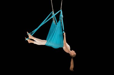 Yerçekimi karşıtı yoga egzersizleri. Aero sinek yogası. Hava jimnastiği. Hamak kullanan bir kadın. Siyah arkaplanda tam boy portre izole edildi