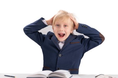 Boy doing homework. Schoolboy grabbing head and screaming. Overloaded child. Portrait isolated on white background