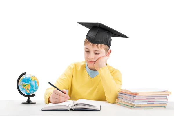 Tired Schoolboy Does Homework Sitting Desk Boy Students Hat Writing — Stockfoto