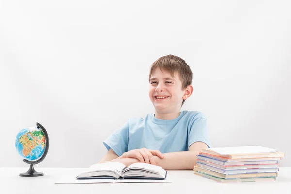 Cheerful Laughing Teenage Boy Sits Table While Doing His Homework — Stock Fotó