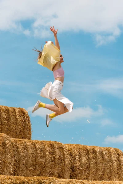 Young Woman Jumps Haystack Her Hands Raised High Countryside Holiday — Photo