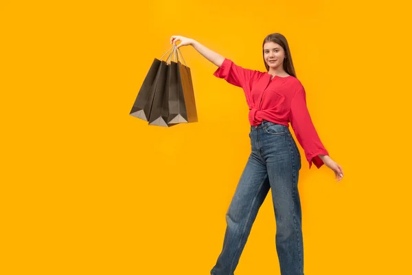 Teenage Girl Holds Black Paper Bags Bright Yellow Background Concept — Stock Photo, Image