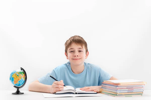 Boy Middle School Does Homework Schoolboy Sits Table Notebook Globe — Fotografia de Stock