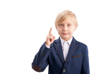 Junior high school student in school uniform serious looking into camera and raising index finger up. Isolated on white background
