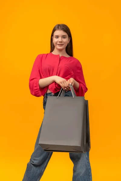 Beautiful Young Woman Holds Paper Black Shopping Bag Yellow Background — Stok fotoğraf